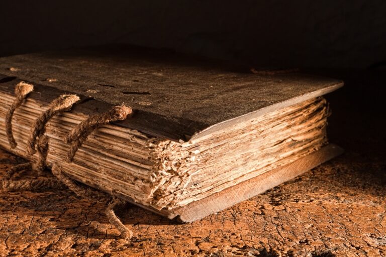 Old book on table with string binding and wooden covers