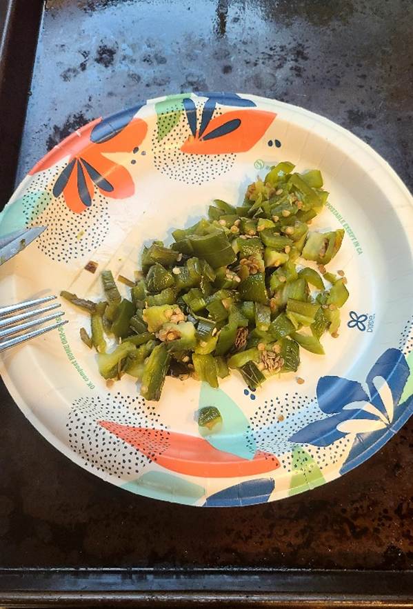 Chopped jalapeno peppers sitting on a paper plate